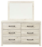 Beige dresser with attached mirror and six drawers, black bar hardware