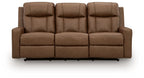 Light brown reclining sofa with tall padded back cushions and segmented seat panels