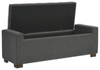 Gray upholstered storage bench with hinged flip-top lid and padded sides