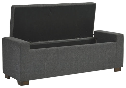 Gray upholstered storage bench with hinged flip-top lid and padded sides