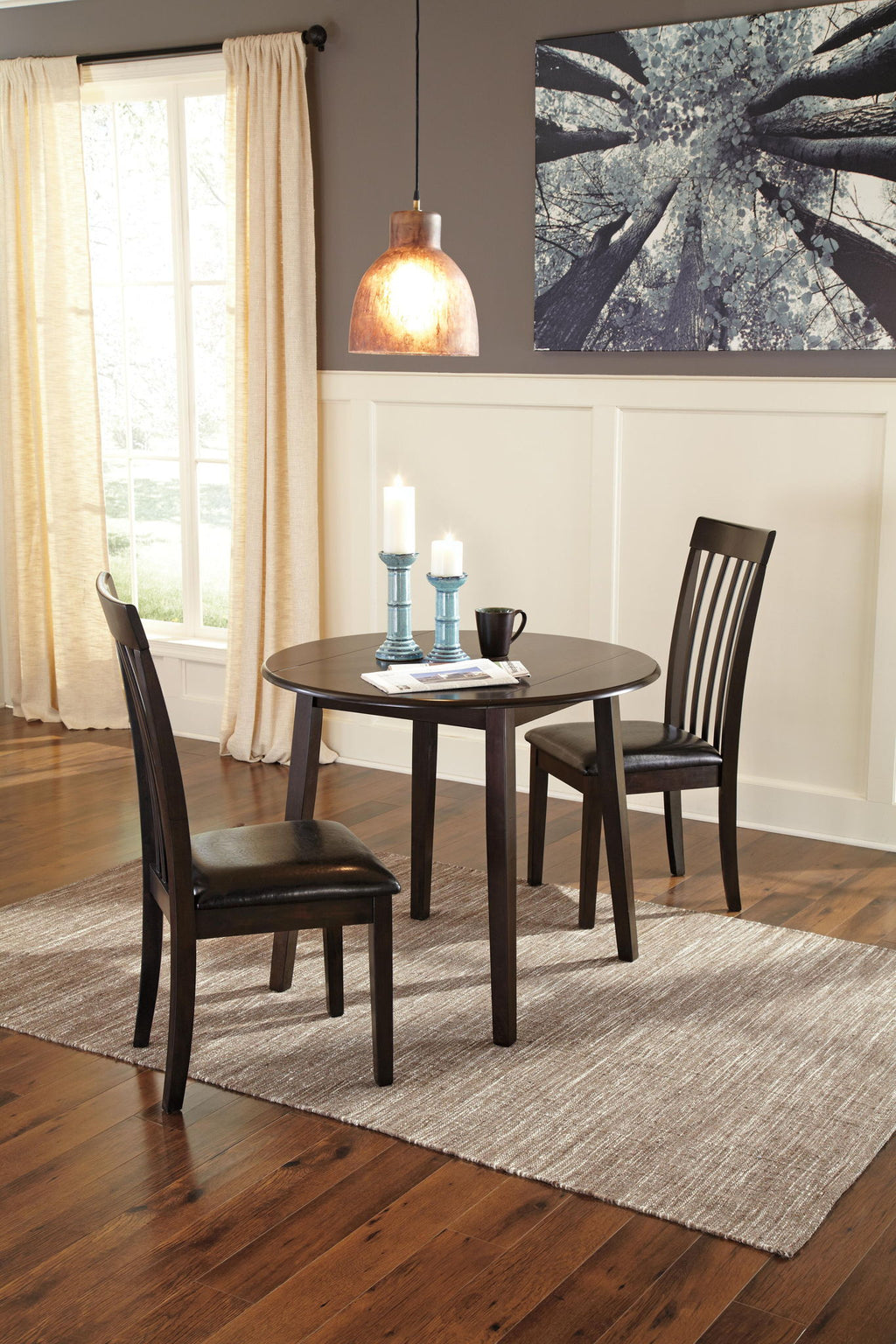 Dark brown round drop-leaf table with smooth top and straight tapered legs