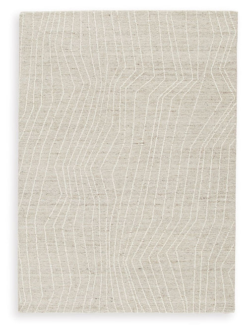 Cream rug with subtle linear wave pattern across the surface
