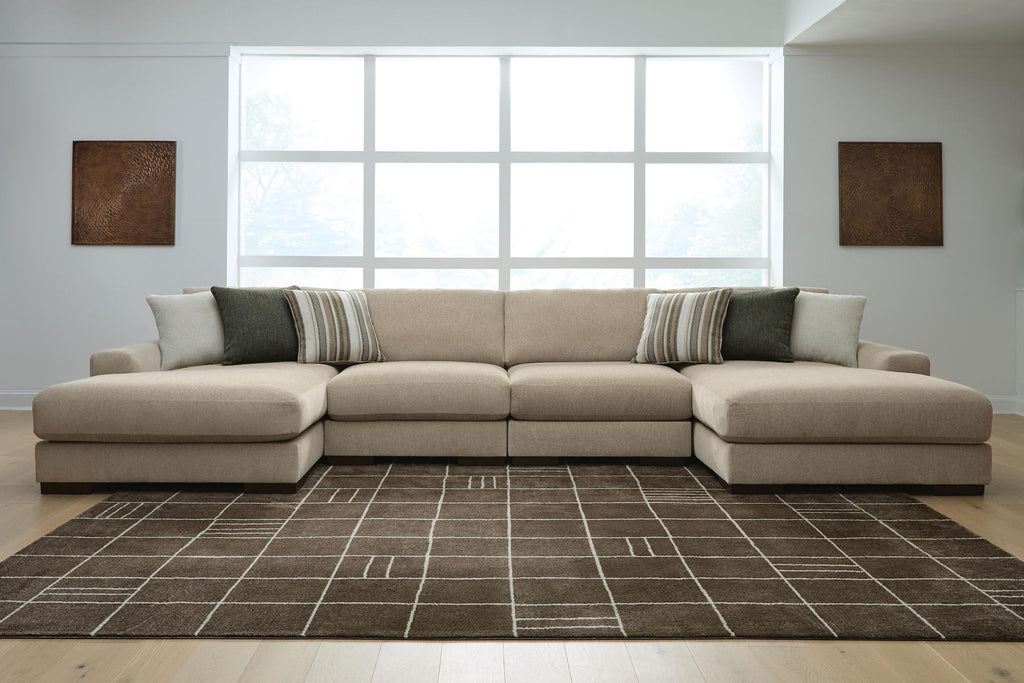 Light brown sectional sofa with chaise ends and striped accent cushions