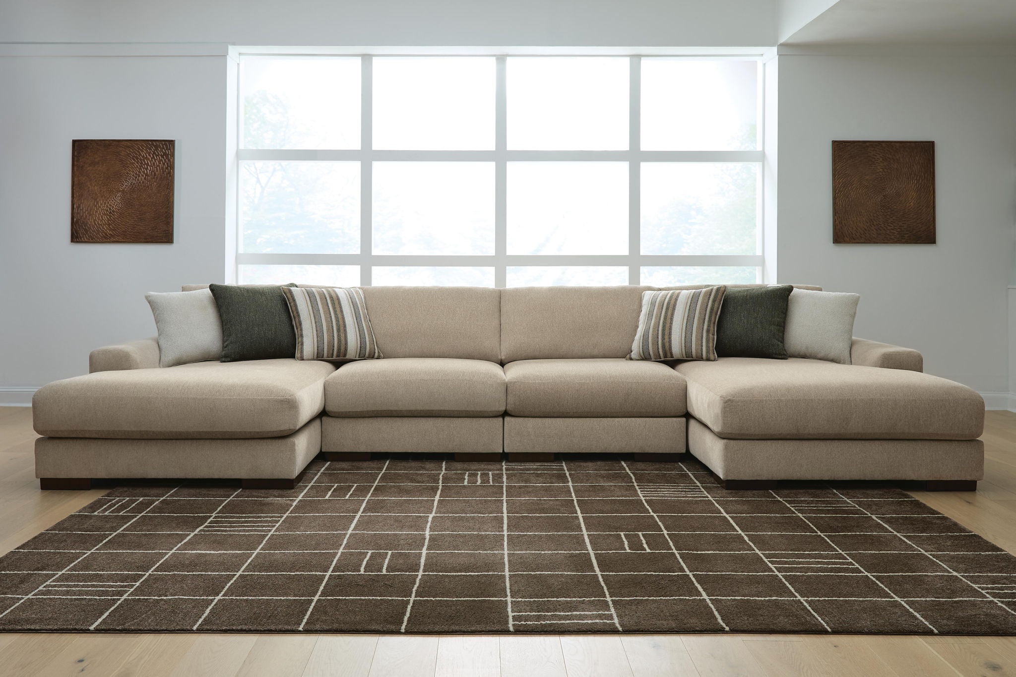 Light brown sectional sofa with chaise ends and striped accent cushions