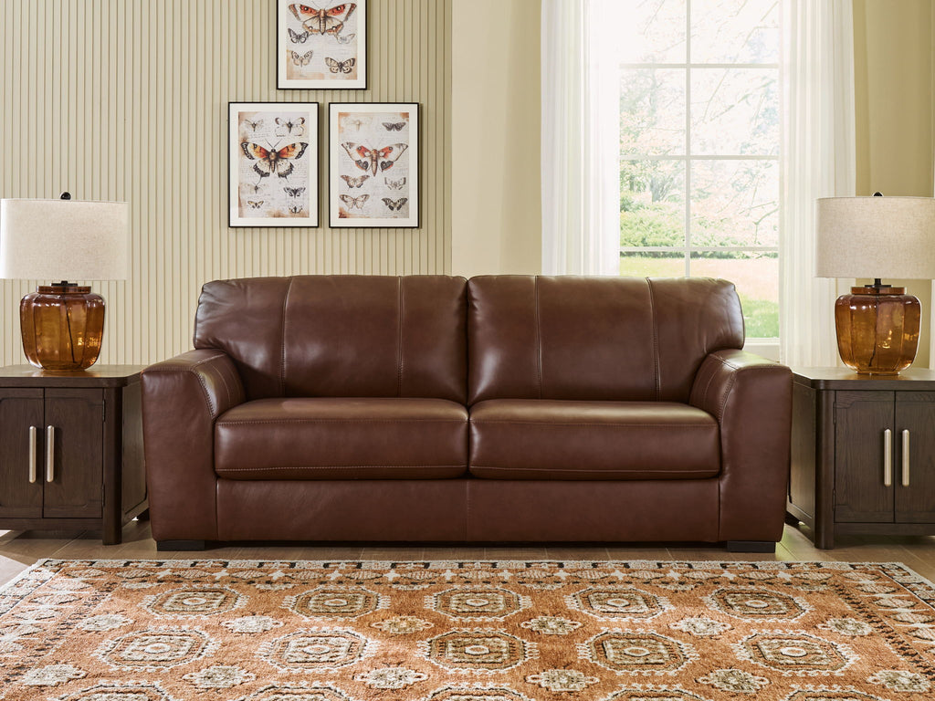 Brown leather sofa with two seat cushions and padded armrests