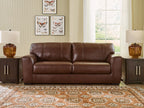 Brown leather sofa with two seat cushions and padded armrests