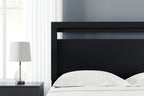 Black queen headboard above bed with white bedding