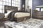 Panel bed with dark wood frame and panel headboard, styled with light and dark bedding