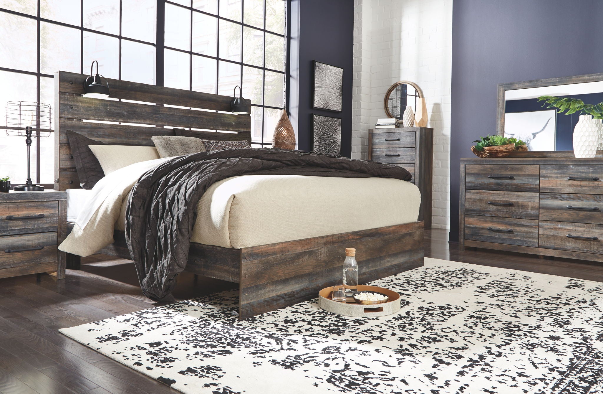 Panel bed with dark wood frame and panel headboard, styled with light and dark bedding