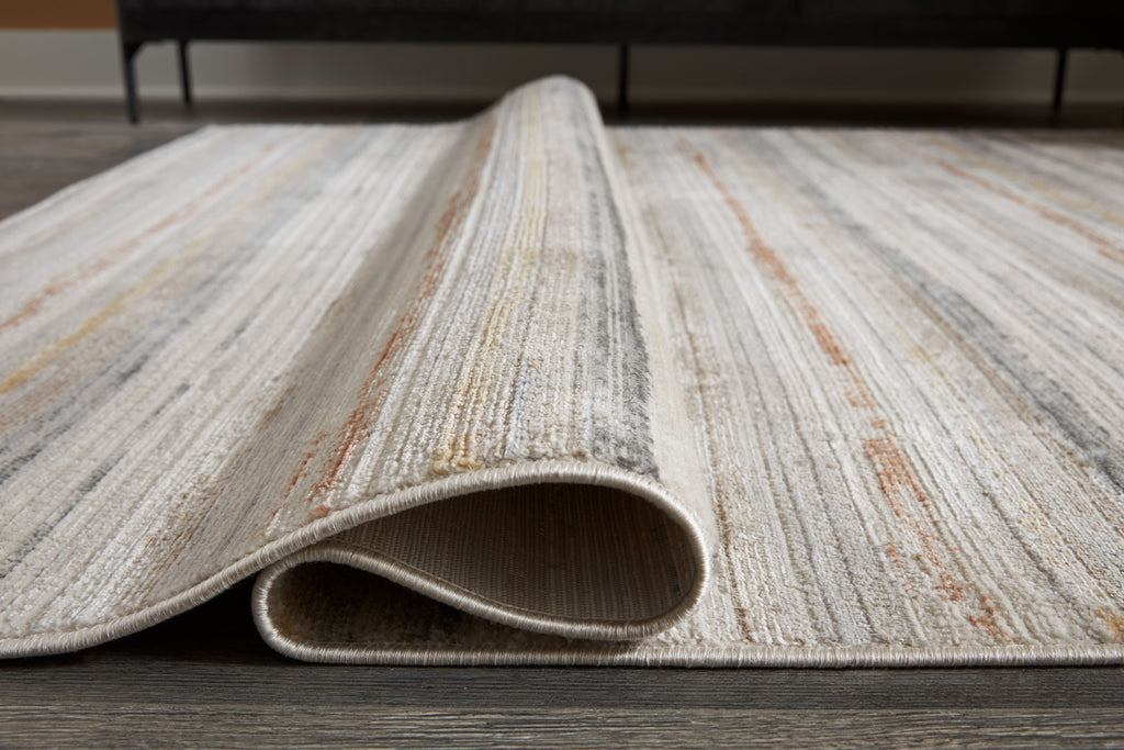 Artney rug with light brown and gray striped pattern, rolled edge view