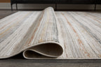 Artney rug with light brown and gray striped pattern, rolled edge view