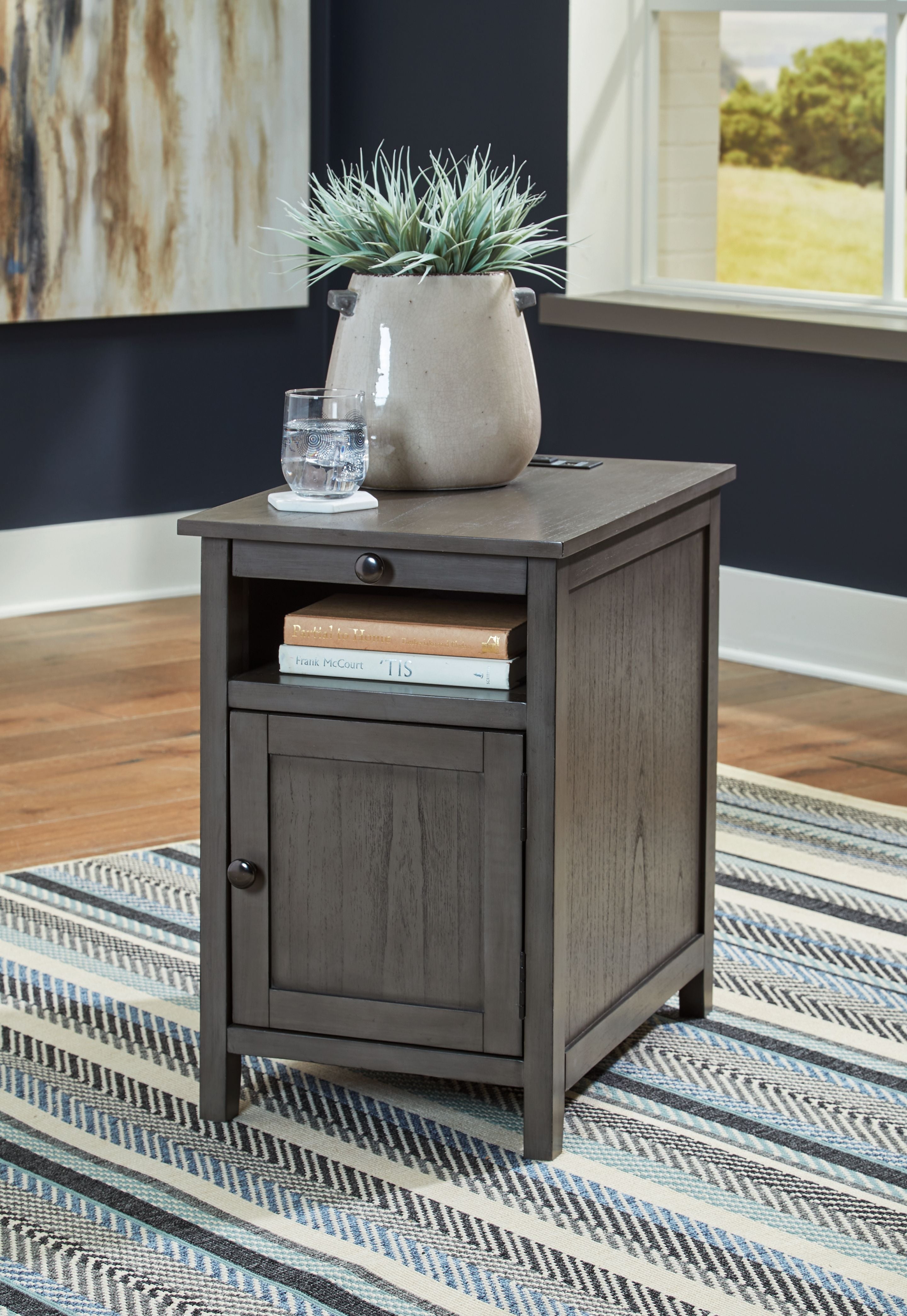 Dark gray chair side end table with cabinet door and top drawer, round knobs