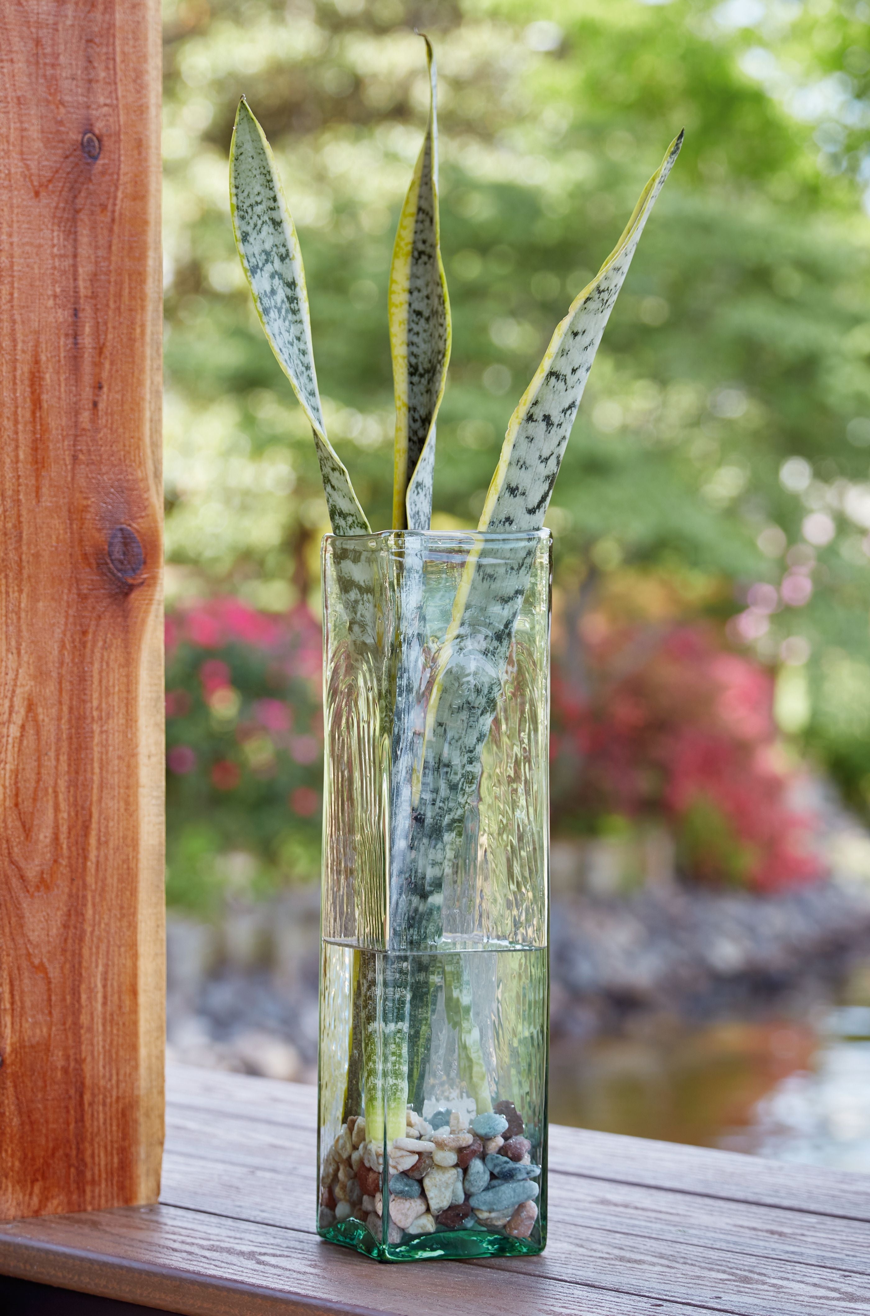 Taylow green glass vase filled with decorative rocks and stems