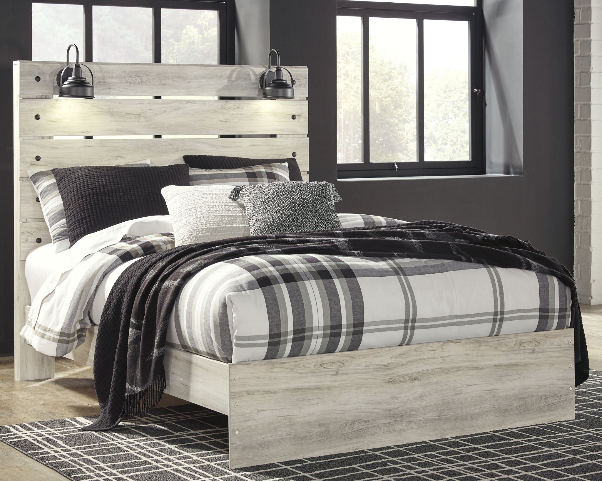 Light wood panel bed with two side drawers; black and white plaid bedding with gray accent pillows