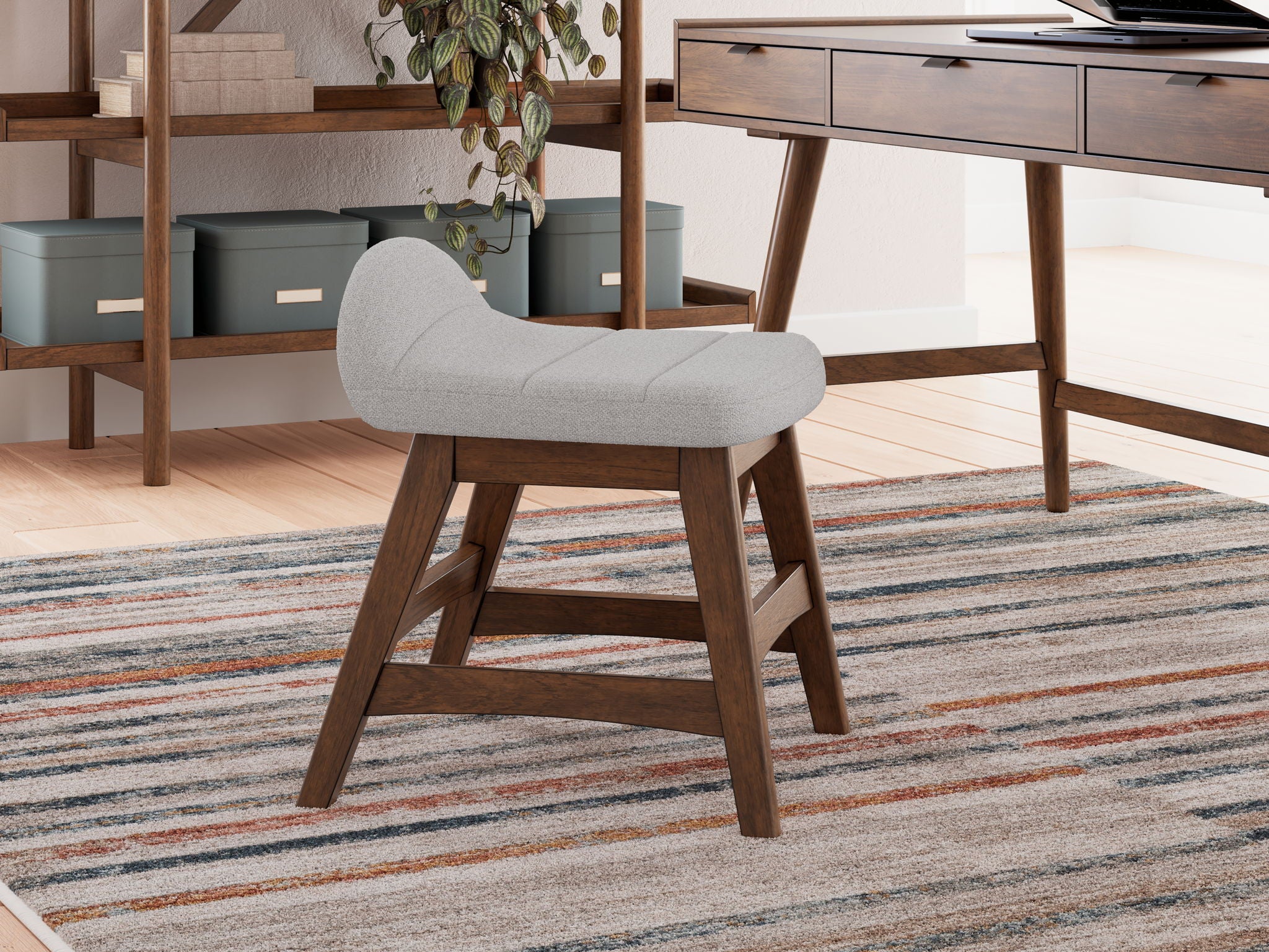 Light gray upholstered desk chair with curved seat and back, wooden legs
