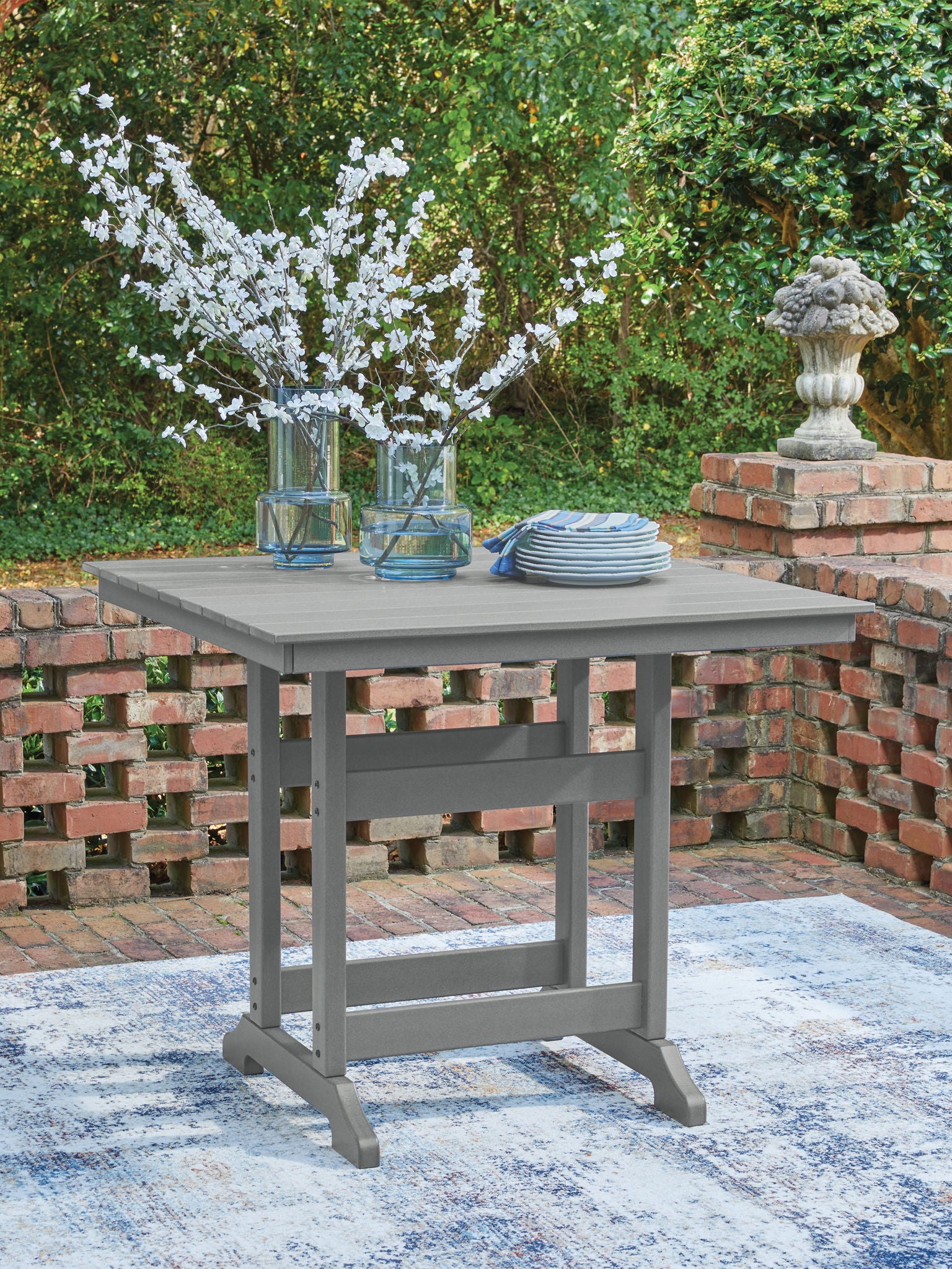 Dark gray square counter table with slatted top and open lower shelf
