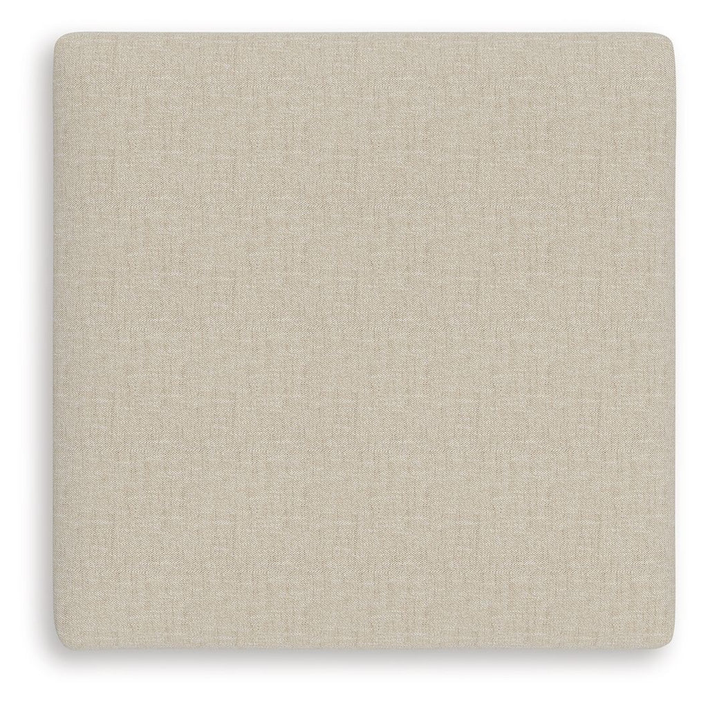 Light beige square ottoman cushion with smooth twill-like fabric texture