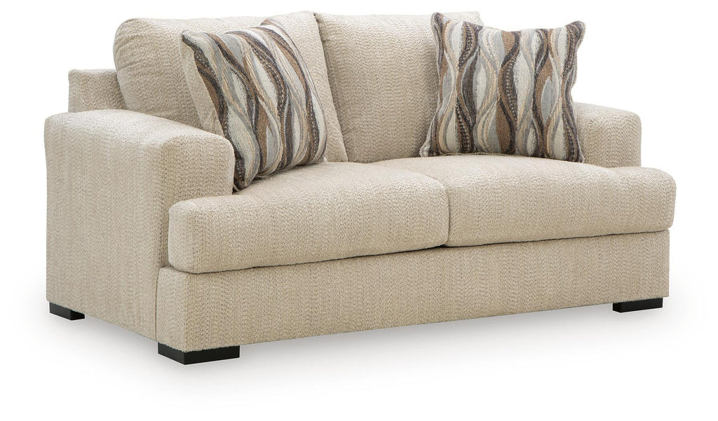 Beige loveseat with squared arms, two seat cushions, and two striped accent pillows