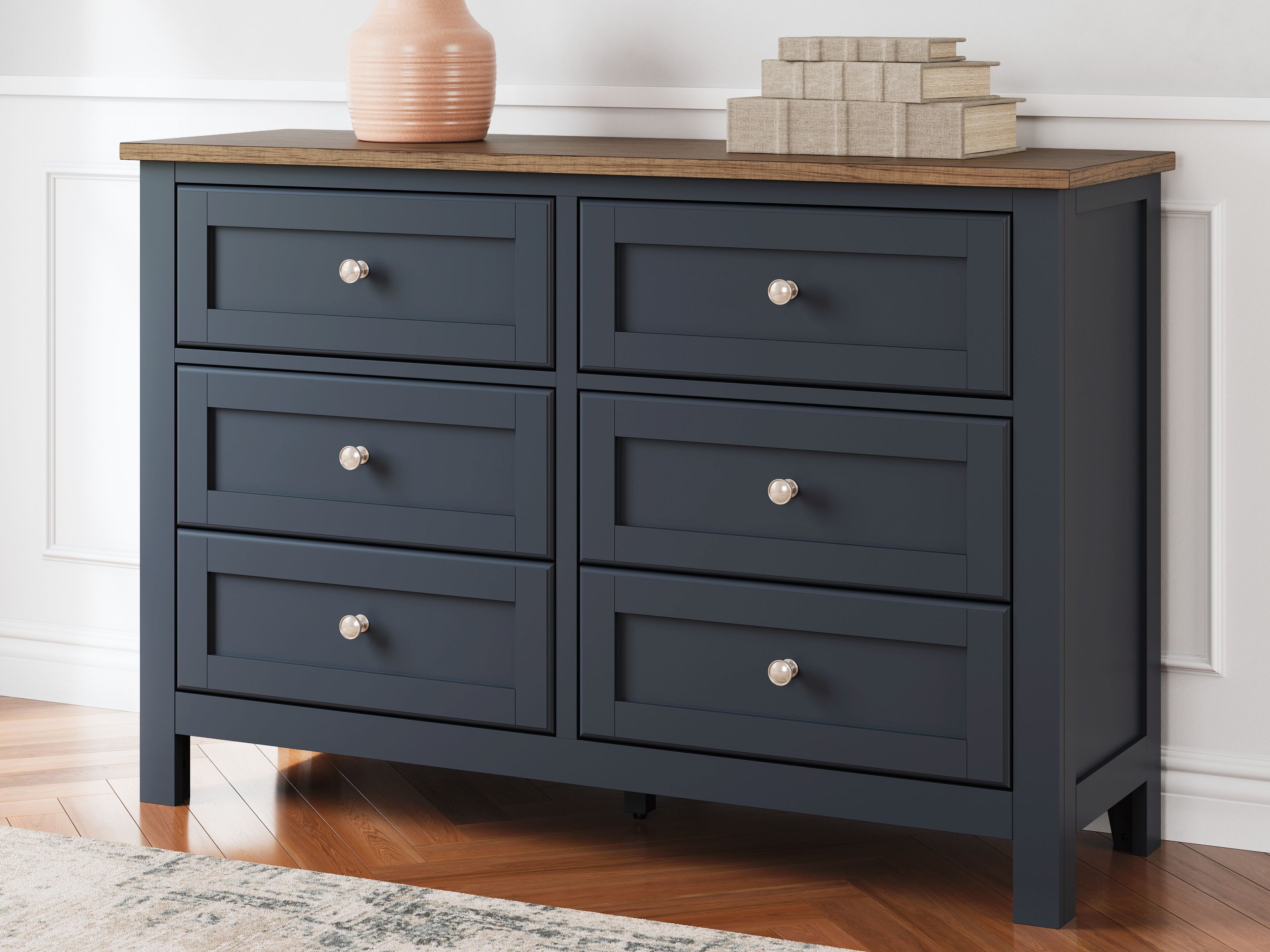 Blue dresser with six drawers, round silver knobs, and brown wood top