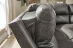 Dark gray power recliner backrest with stitched seams and armrest