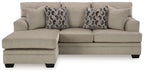 Taupe sofa chaise with three seat cushions and two geometric patterned throw pillows