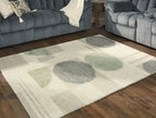 Ivory rug with abstract circles in gray and sage, low pile texture