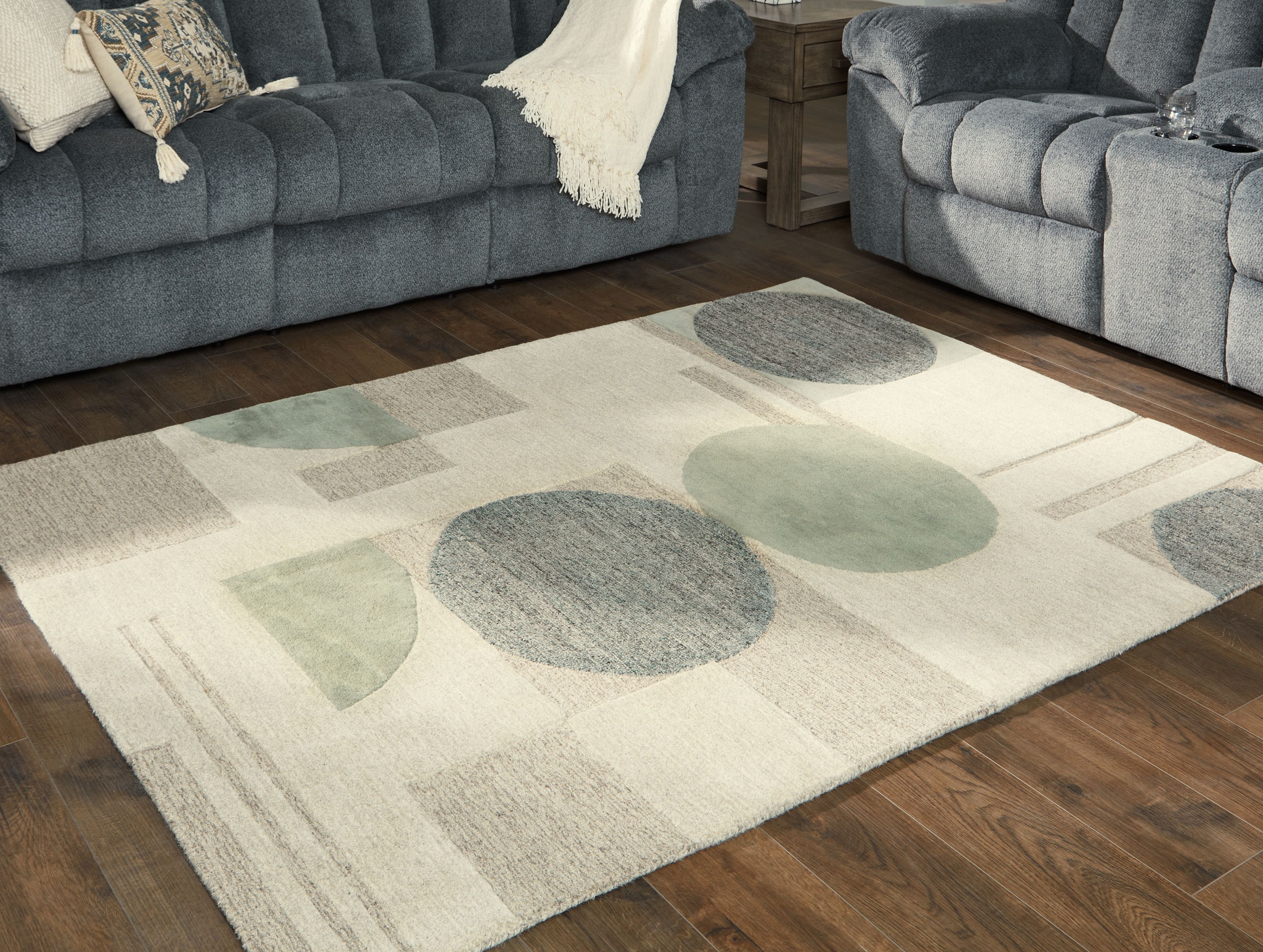 Ivory rug with abstract circles in gray and sage, low pile texture