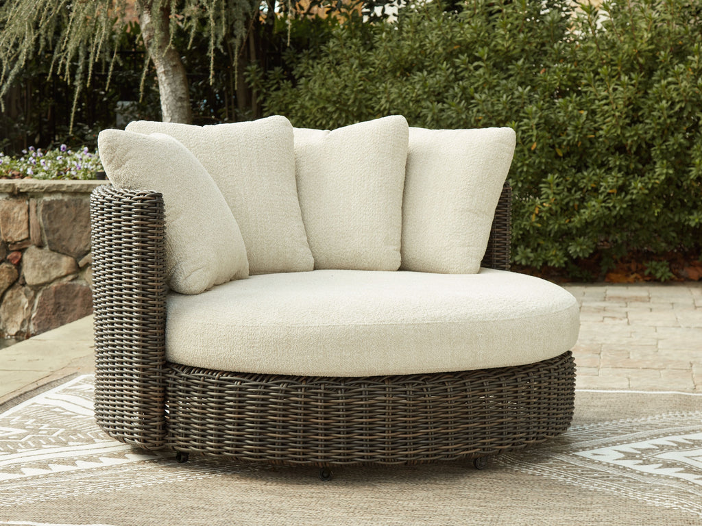 Swivel lounge chair with cushion, beige fabric on dark brown wicker base and round arms