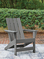 Gray Adirondack chair with slatted back and wide arms, outdoor seating