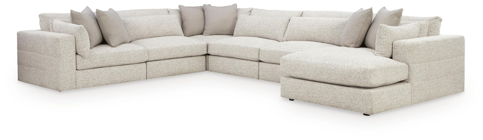 Beige sectional sofa with corner and long chaise, deep seats, boxy arms, and pillows
