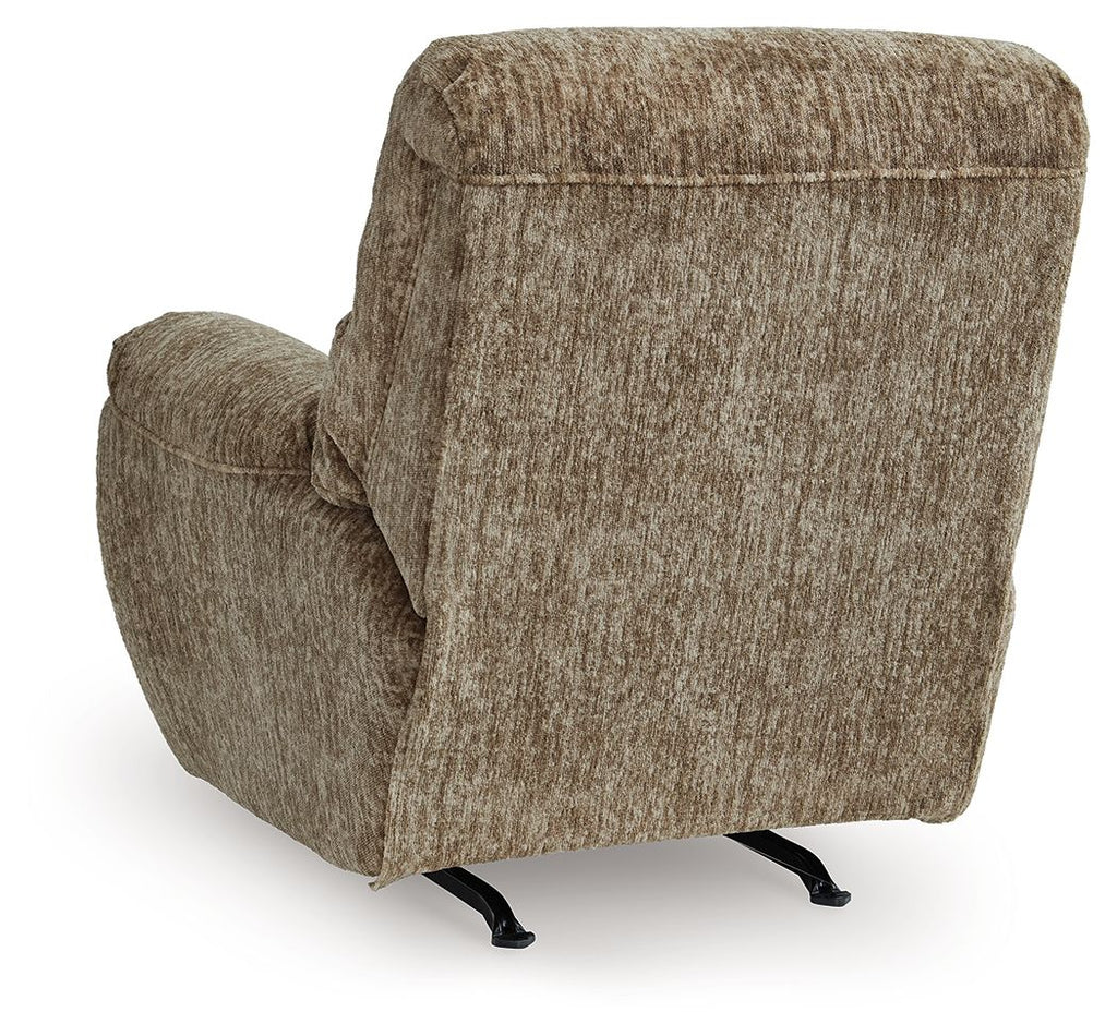 Taupe rocker recliner chair with curved back, thick armrests, and angled foot base