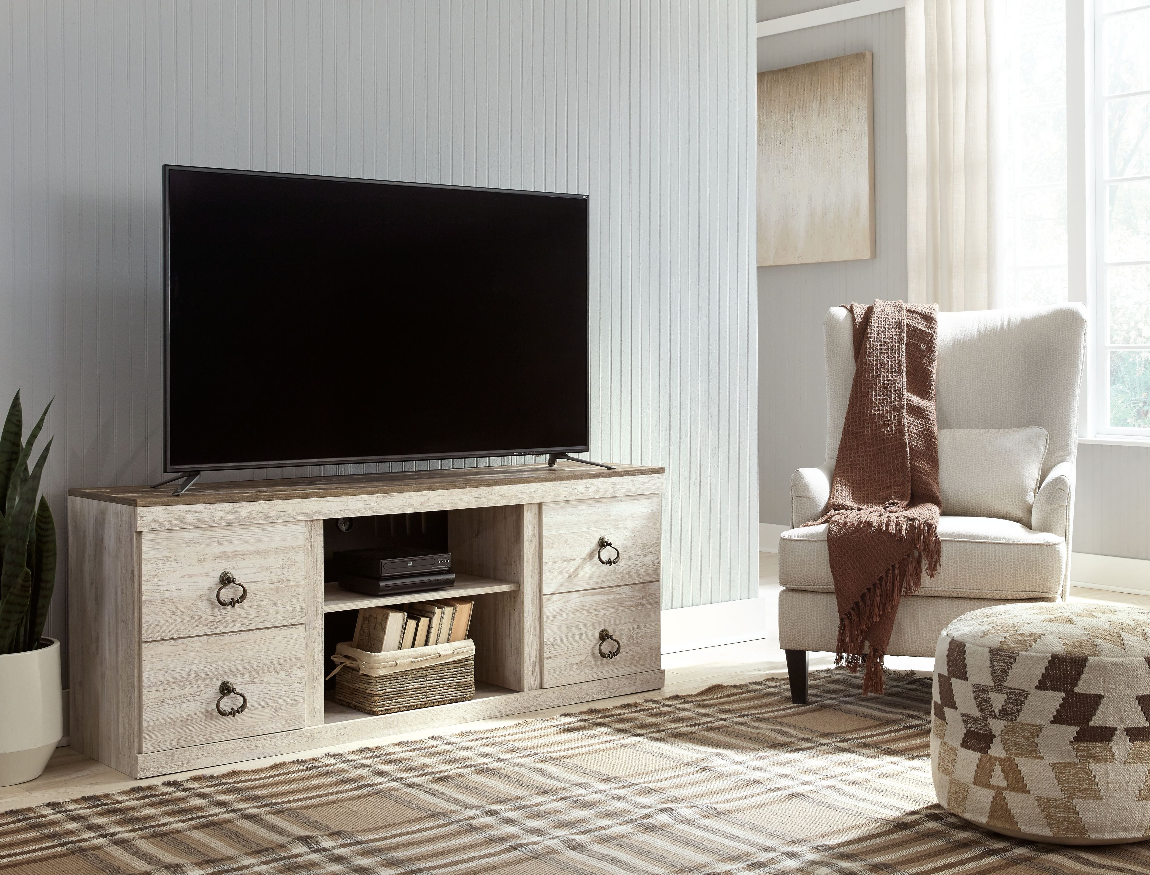 Willowton TV stand with fireplace: light wood console with TV mount, firebox, and drawers