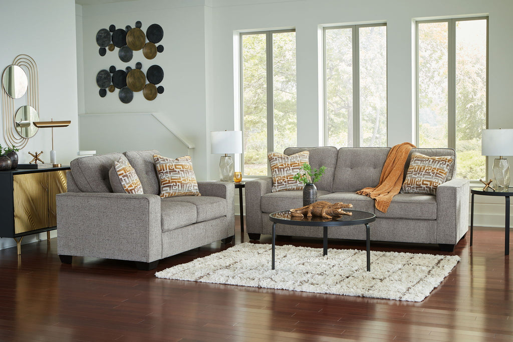Gray fabric living room set with two seating pieces and patterned throw pillows