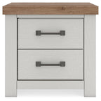 Two-drawer night stand in white with brown tabletop and two dark metal bar handles.