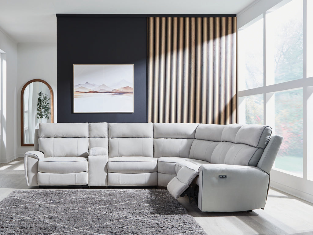 Reclining sectional sofa with light gray upholstery and padded arm, chaise end