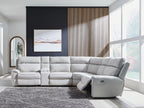 Reclining sectional sofa with light gray upholstery and padded arm, chaise end