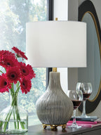 Ceramic table lamp with gray ribbed base, gold stem, and white drum shade