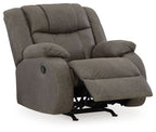 Gunmetal gray recliner with wide armrests, tufted back, and extending footrest