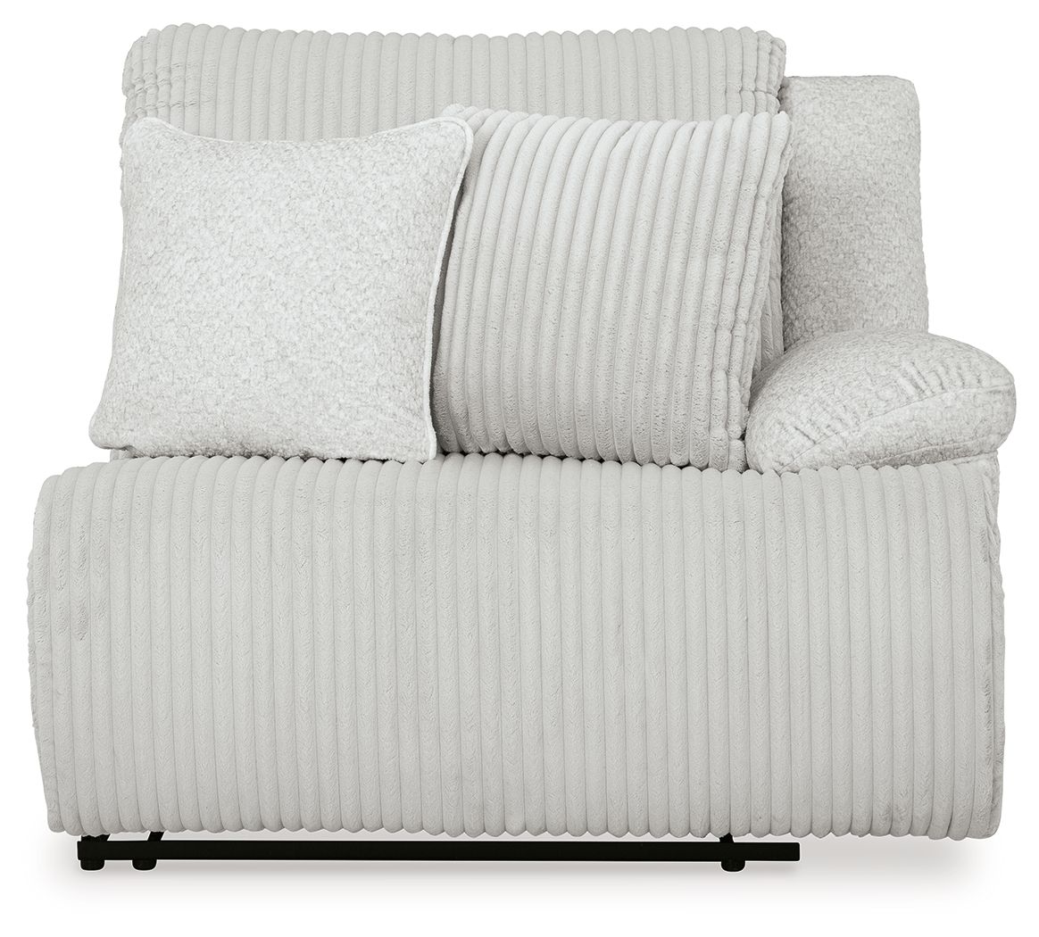 Light gray ribbed power recliner with two accent pillows and rounded armrests