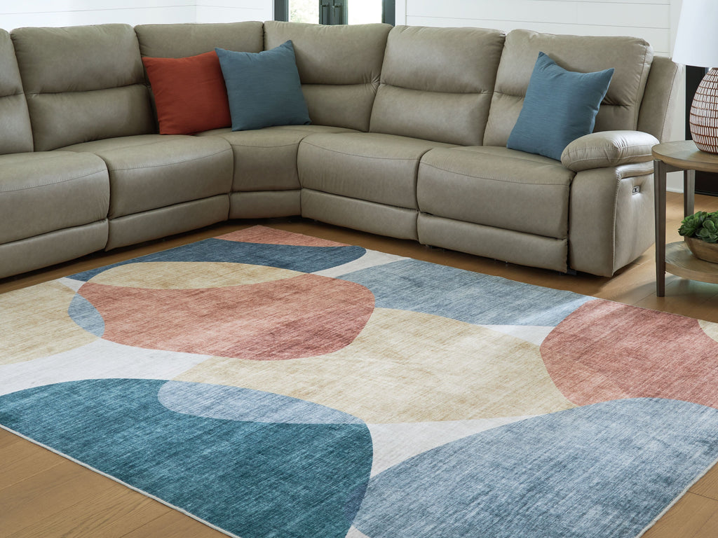 Geometric washable rug with blue, coral, beige, and gray abstract shapes