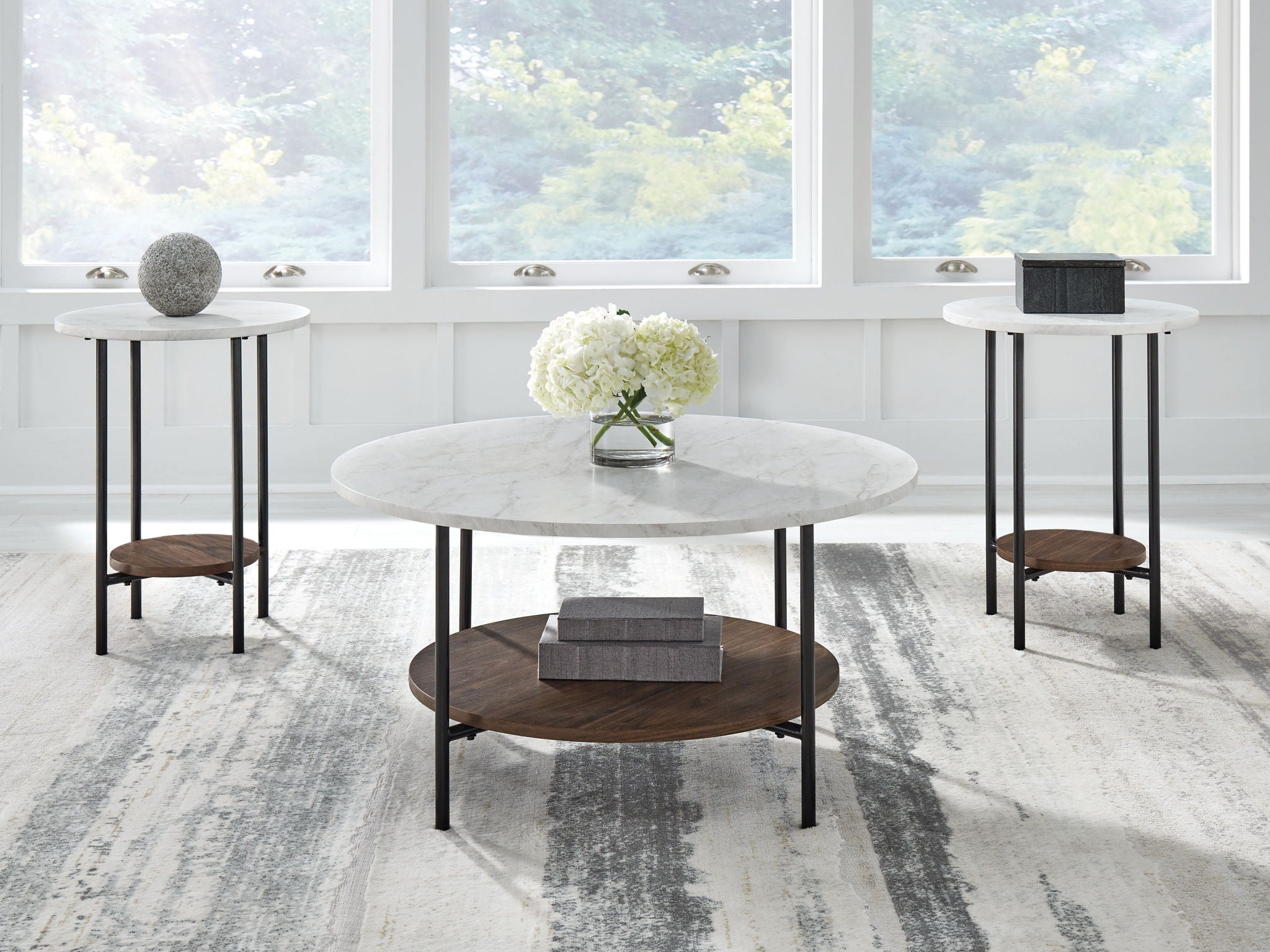 Set of three round occasional tables with gray tops, black frames, wood shelves