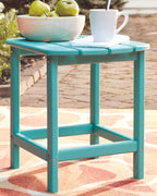 Outdoor end table in light teal with slatted top and lower storage shelf