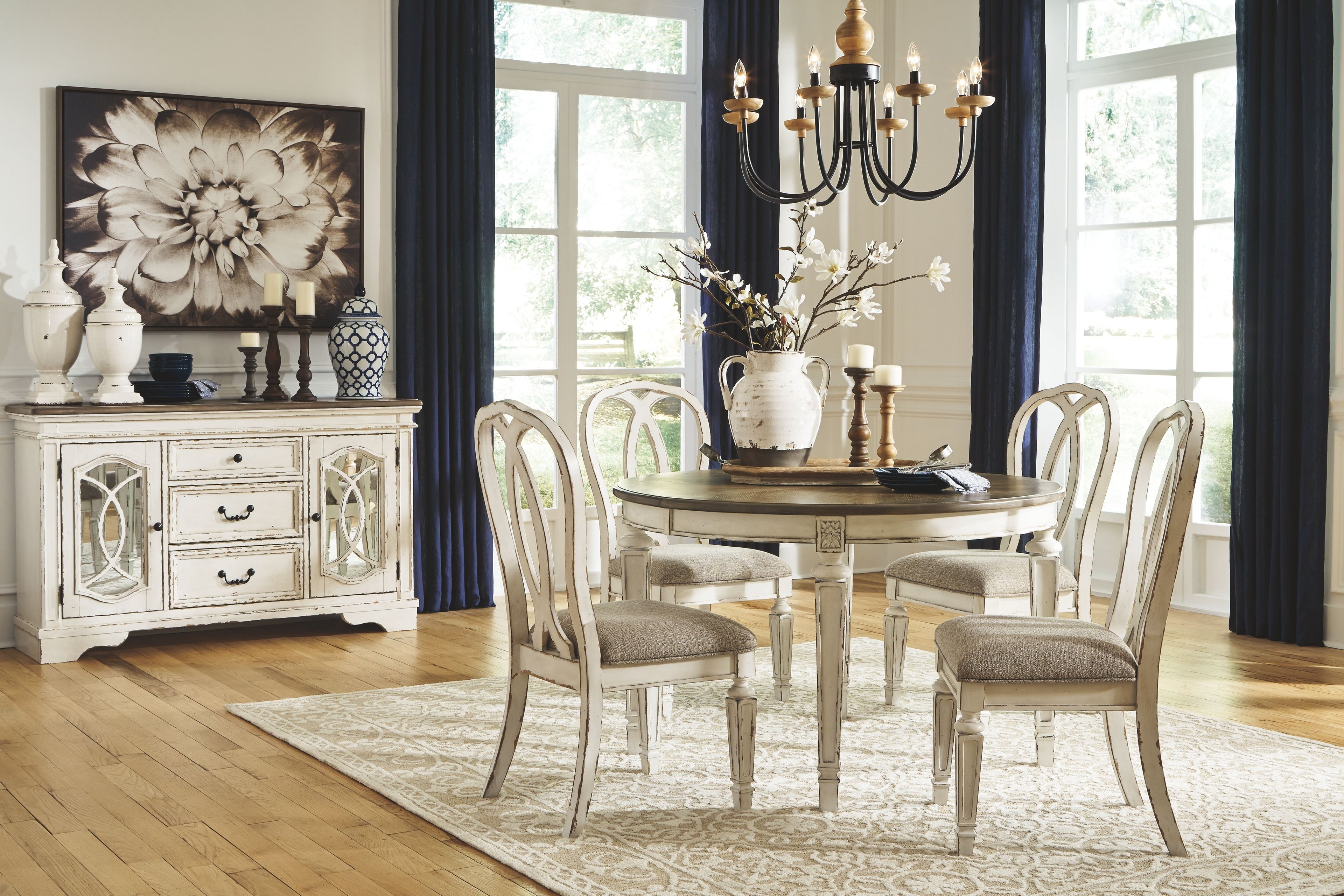 Oval dining table set with white chairs featuring curved ladderbacks and gray-brown top
