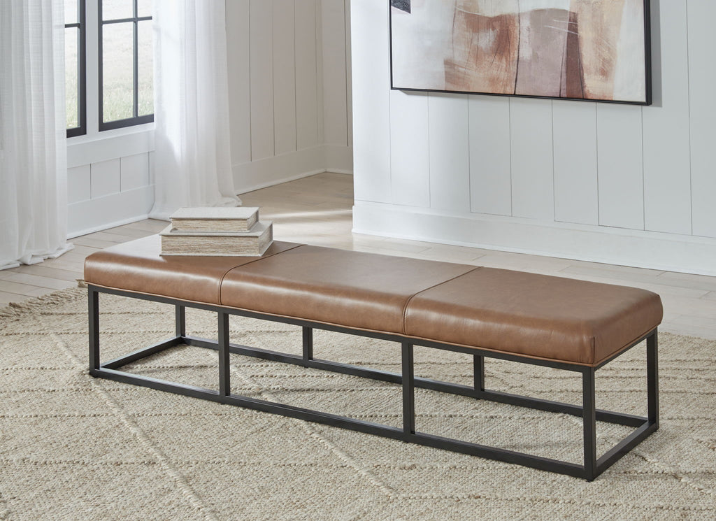 Caramel brown accent bench with tufted cushions and black metal legs