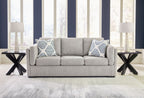 Pewter fabric sofa with two patterned throw pillows and three seat cushions