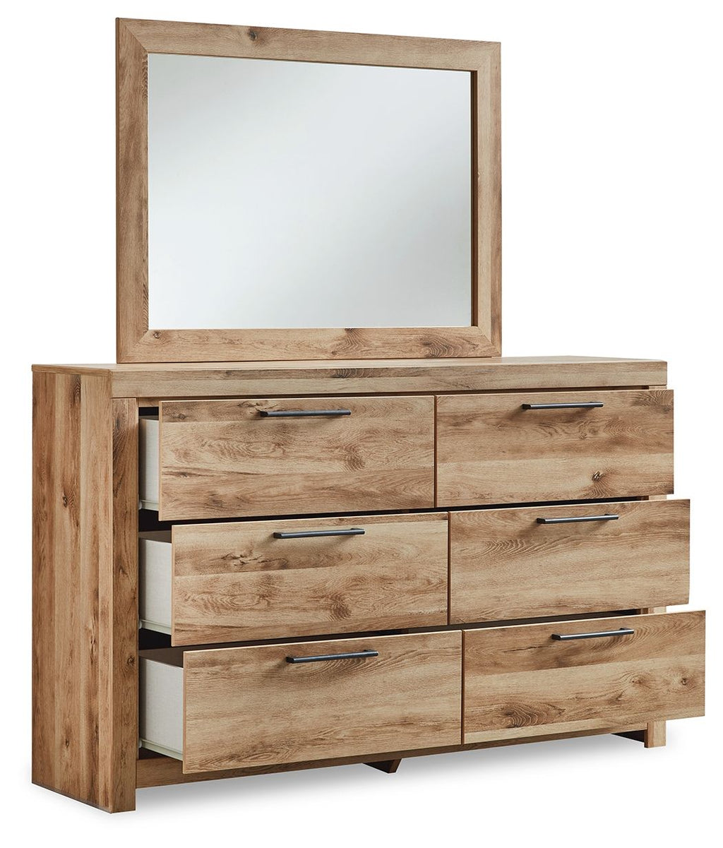 Light beige wood dresser with six drawers and chrome bar pulls plus framed mirror