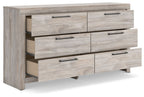 Six-drawer dresser with partially open drawers in light gray wood and dark bar pulls.