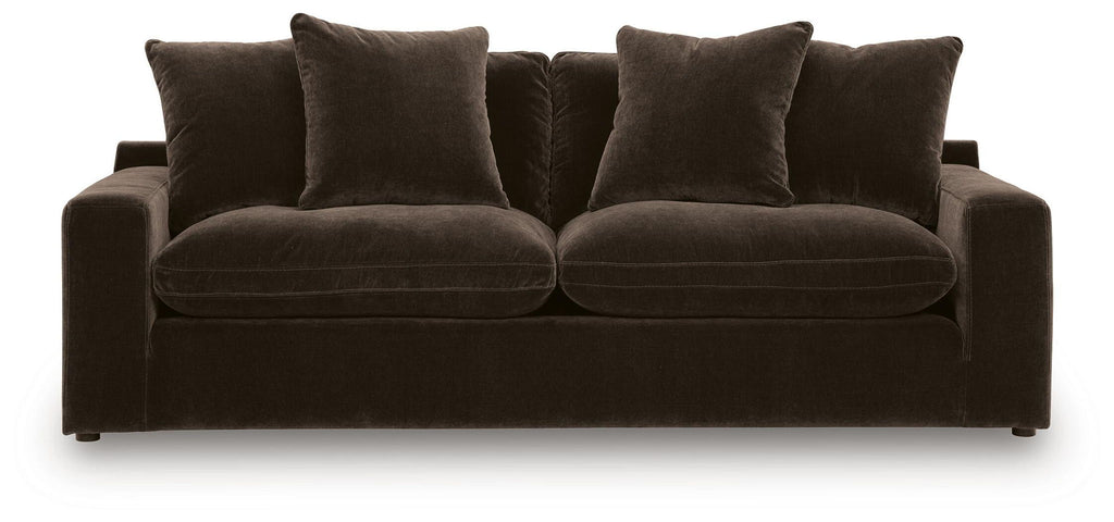 Dark brown fabric sofa with two large seat cushions and four back pillows, low base