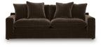 Dark brown fabric sofa with two large seat cushions and four back pillows, low base