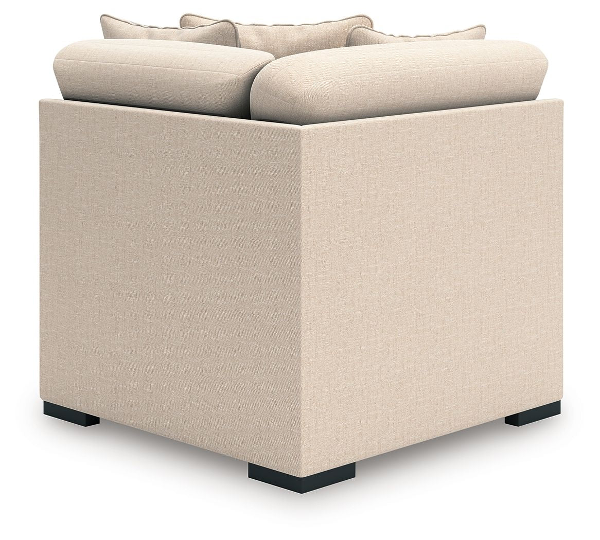 Upholstered wedge chair with light beige fabric cushions and squared arms
